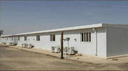 A row of prefabricated modular buildings on site.