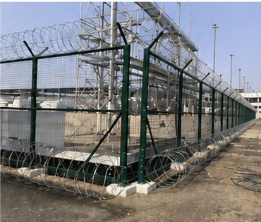 Welded mesh security fencing with razor wire, installed by Al Horafi.
